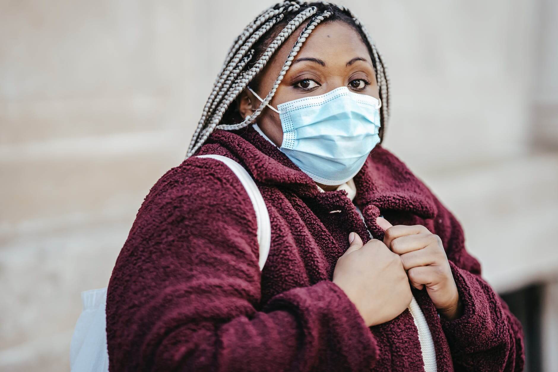 african american woman in mask outside in pandemic